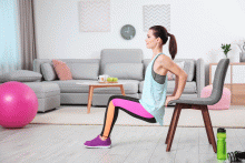 Woman doing a tricep dip with a chair