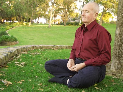 Man sitting under a tree enjoying natural pain relief