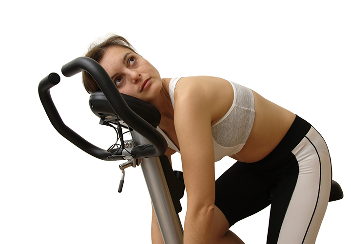 Woman resting after exercise and wondering how much exercise is too much