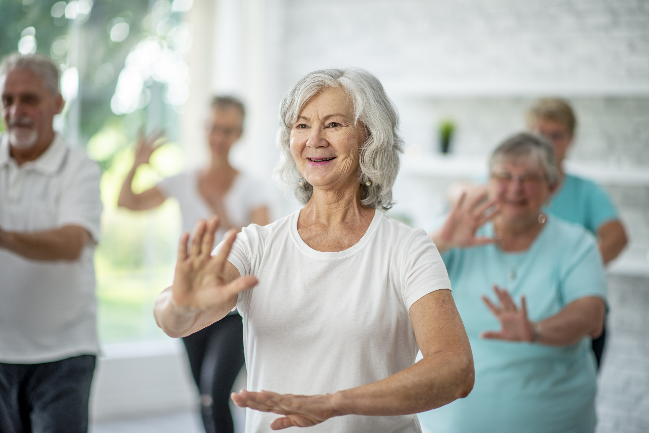 Seniors doing tai chi to relax.