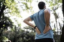 Man feeling backache at a park