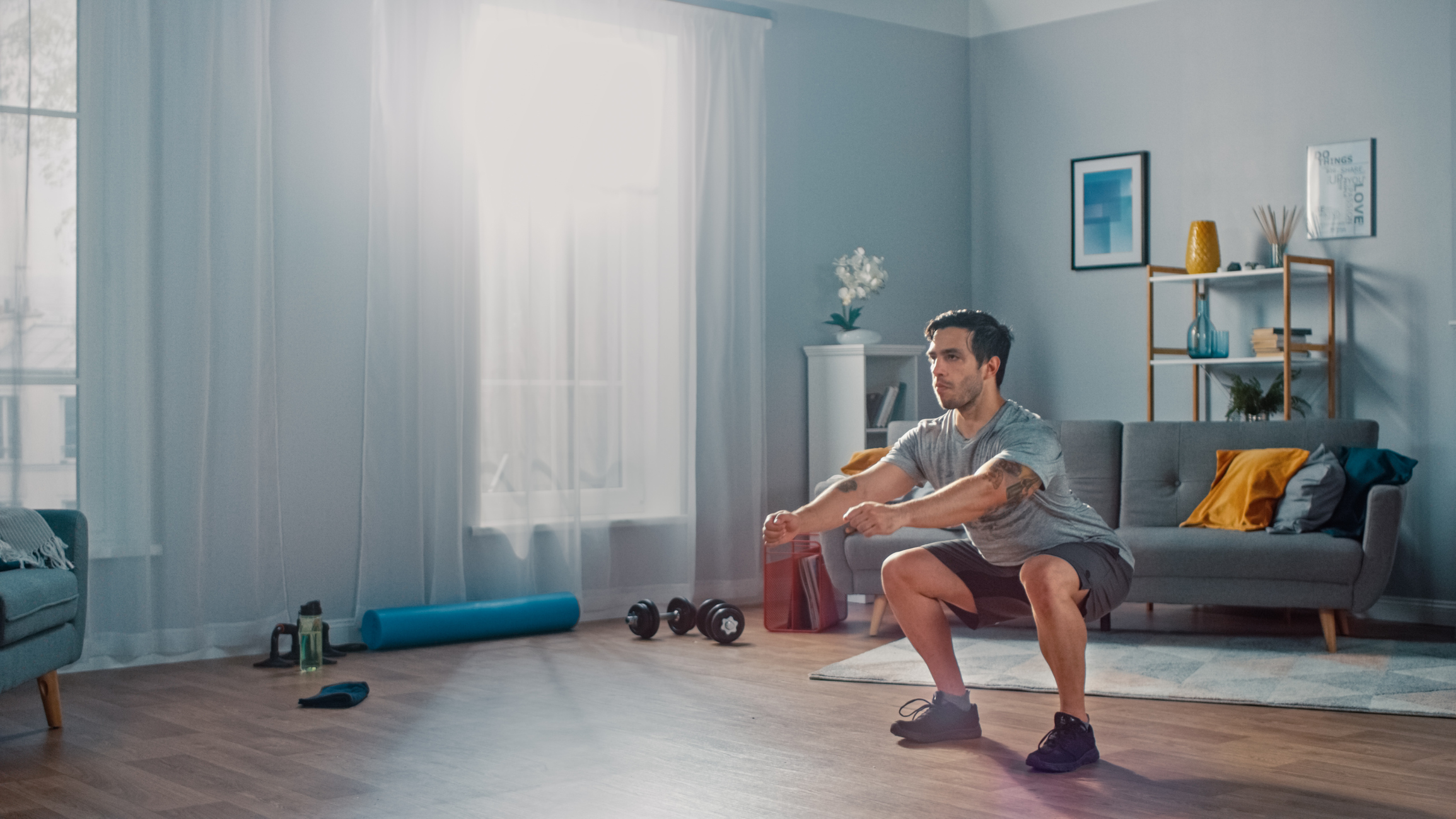 man performing squats in his home gym