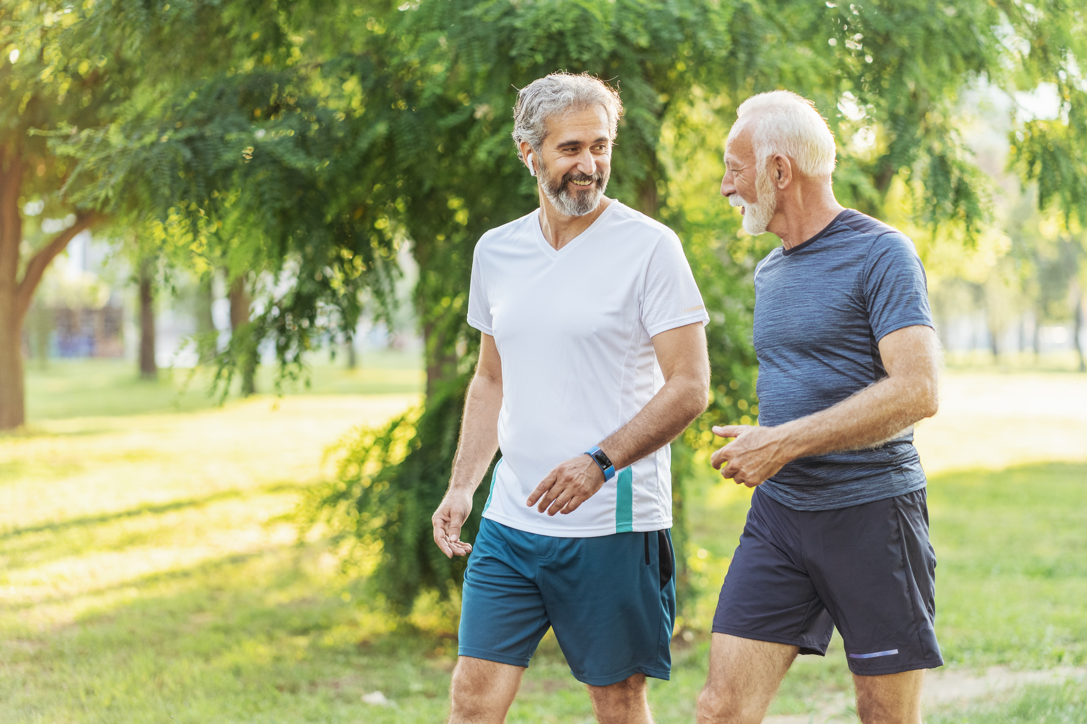 Two men walking in park.