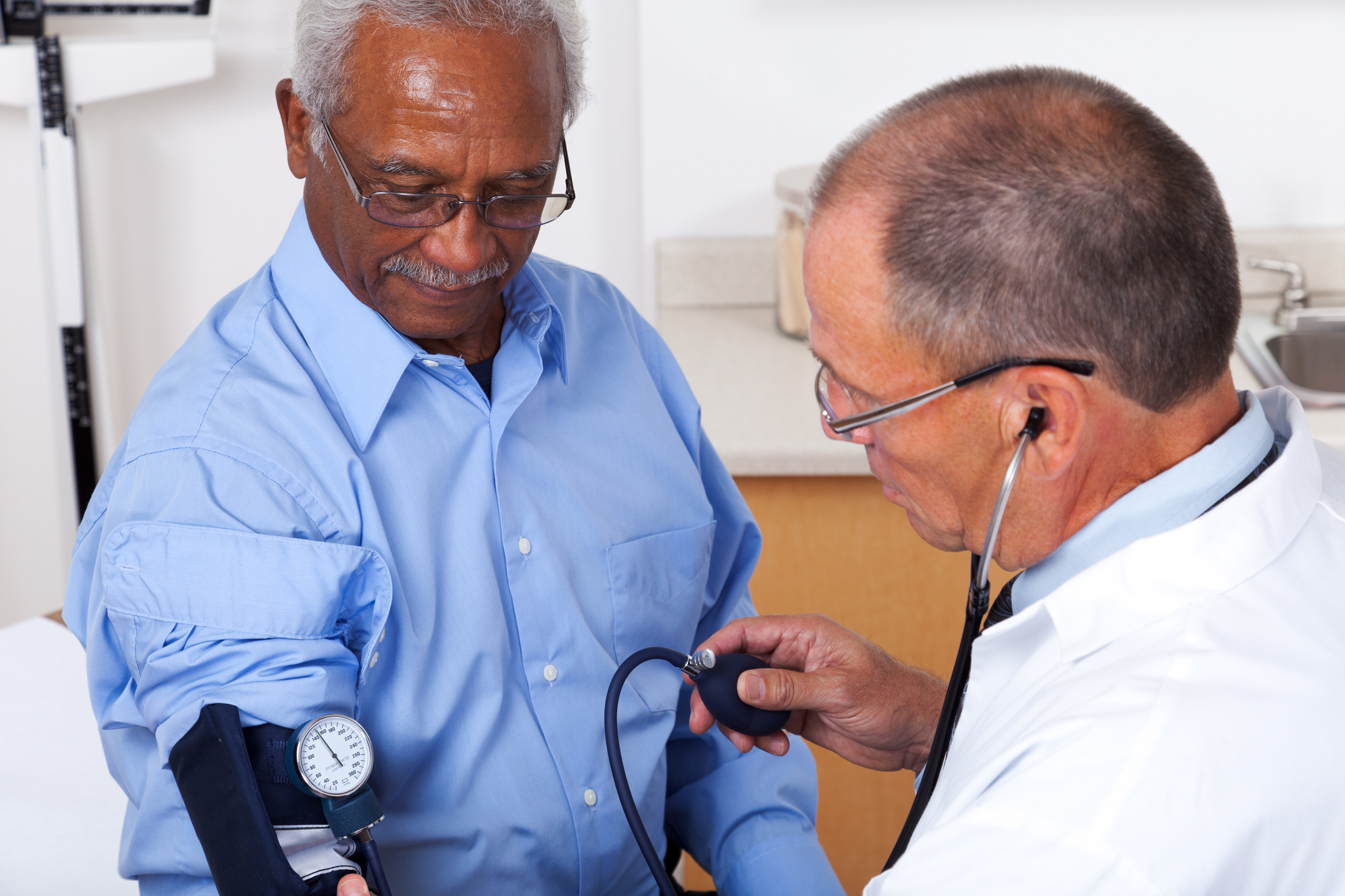 Man having his doctor check his blood pressure