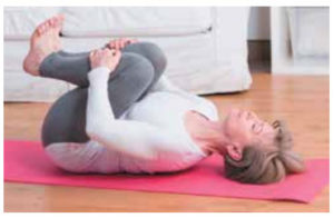 woman performing knees to chest flex test.