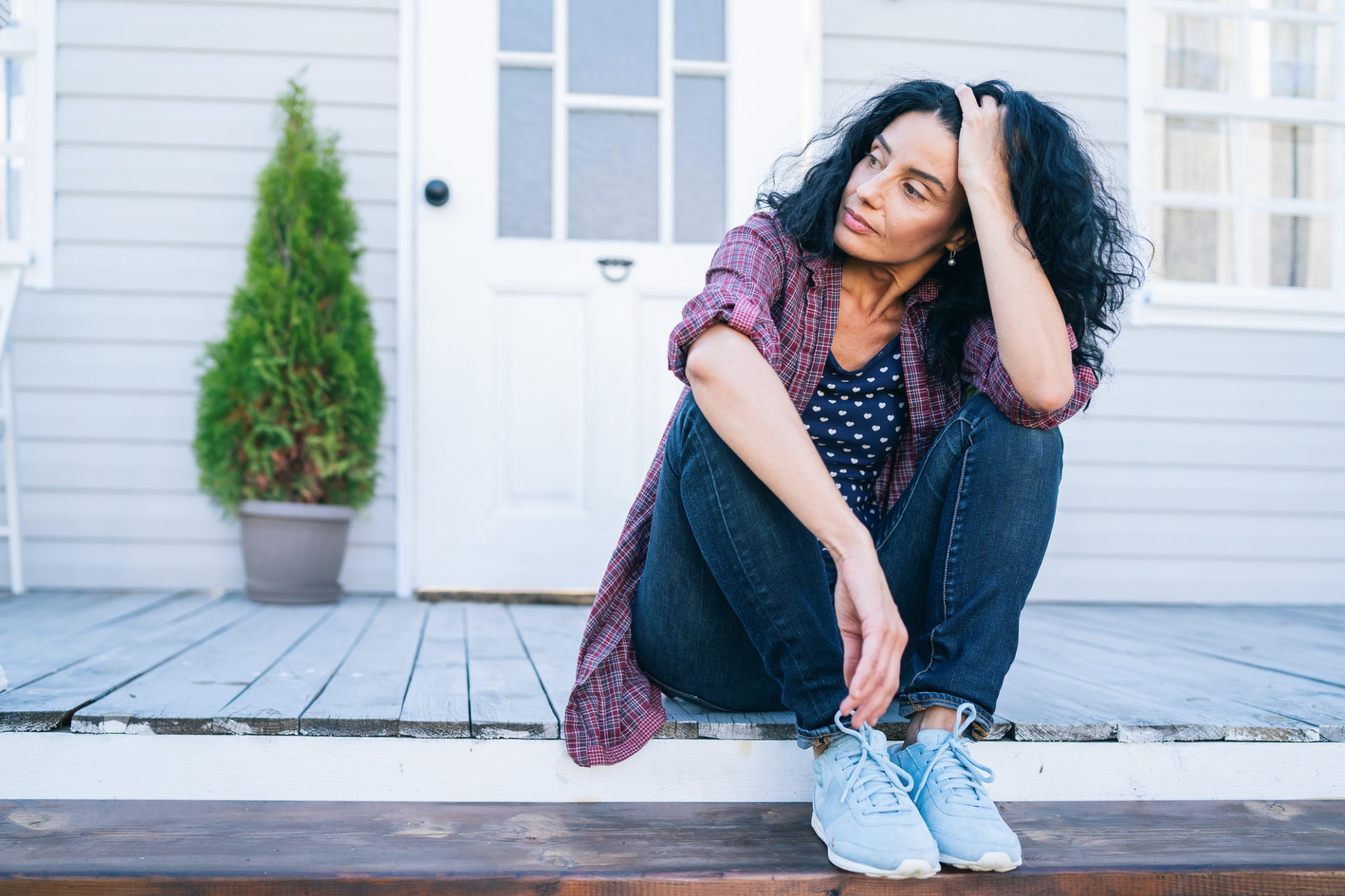 tired woman sitting on stairs what is perimenopause