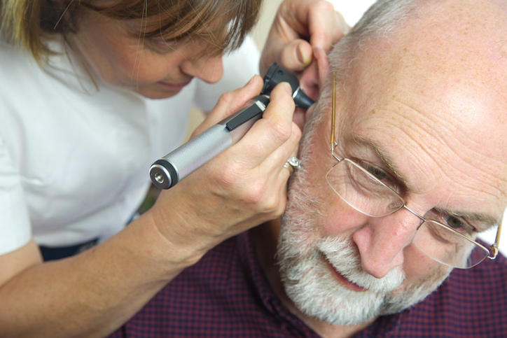 ENT doctor examining patients ear