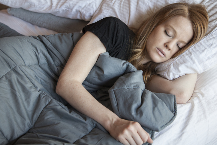 woman sleeping with weighted blanket