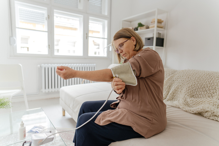 woman checking blood pressure in the morning