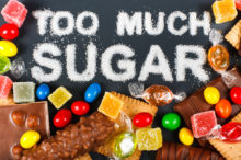 Too much sugar written out in sugar surrounded by candy